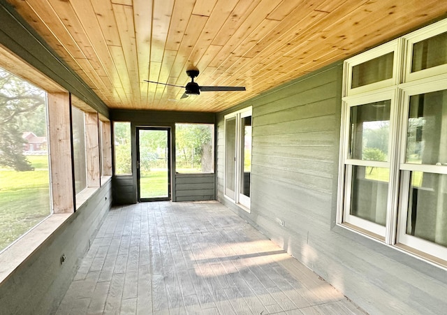 unfurnished sunroom with ceiling fan