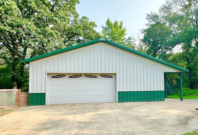 detached garage featuring fence