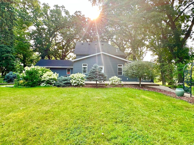 view of side of home with a yard