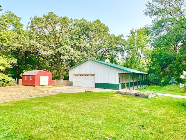 exterior space with a lawn, an outbuilding, and a detached garage
