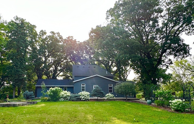 view of side of home with a yard