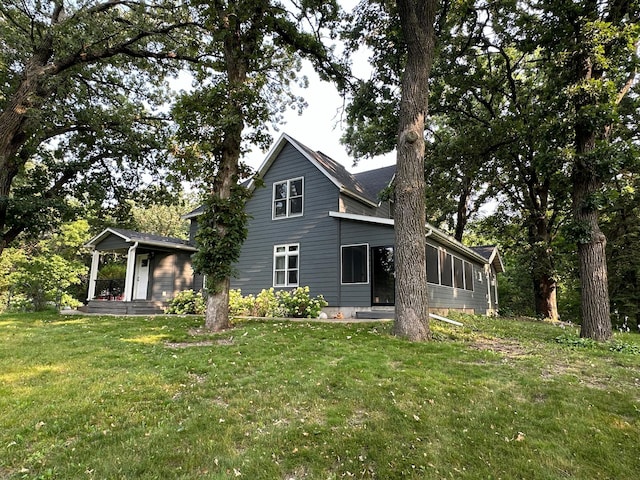 back of property featuring a lawn