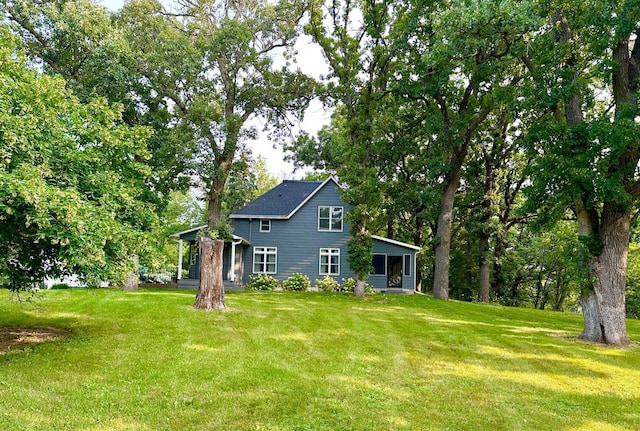 exterior space with a lawn and a sunroom