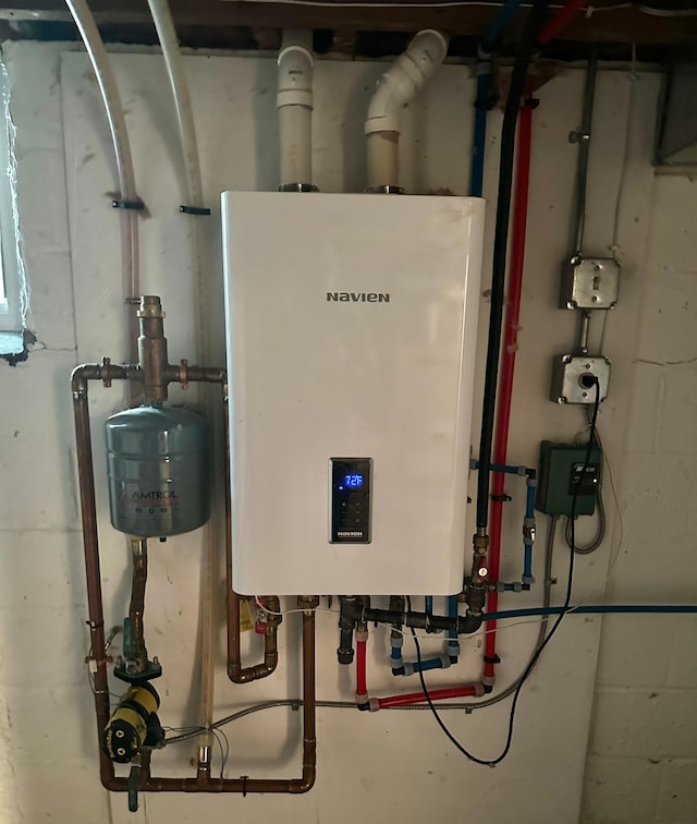utility room featuring tankless water heater