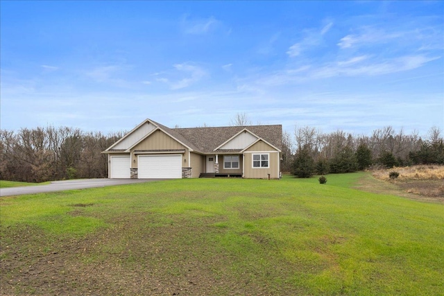 view of front of home with a front yard and a garage