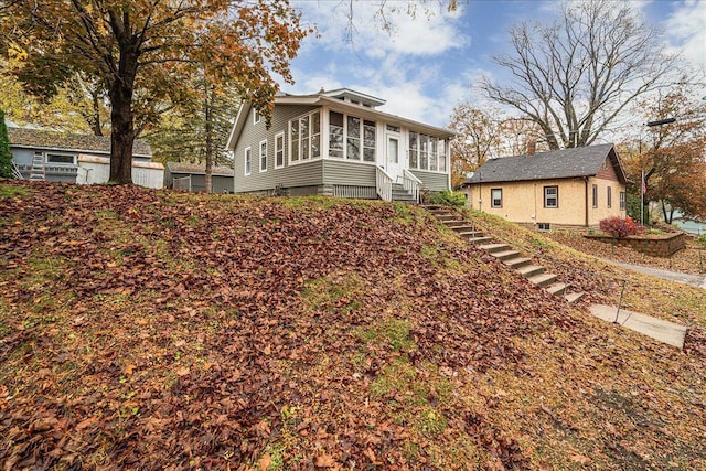 back of property with a sunroom