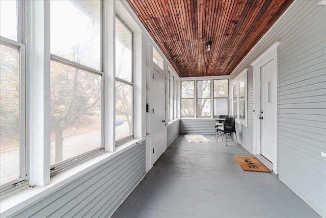 unfurnished sunroom with wood ceiling