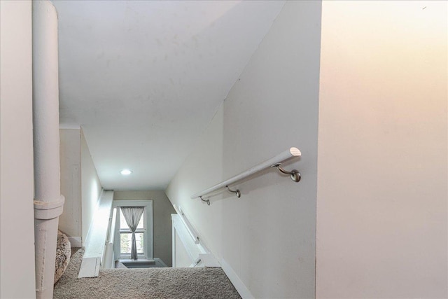 stairway with carpet flooring and vaulted ceiling