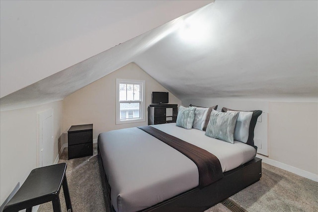 bedroom with lofted ceiling and dark carpet