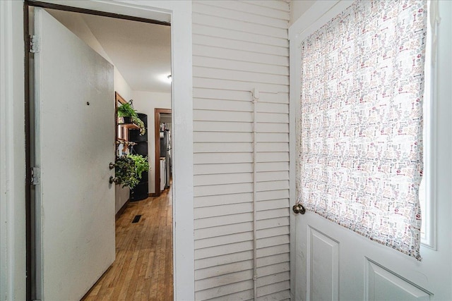 hallway with wood-type flooring