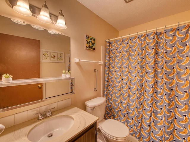 bathroom with vanity, a shower with curtain, toilet, and a textured ceiling