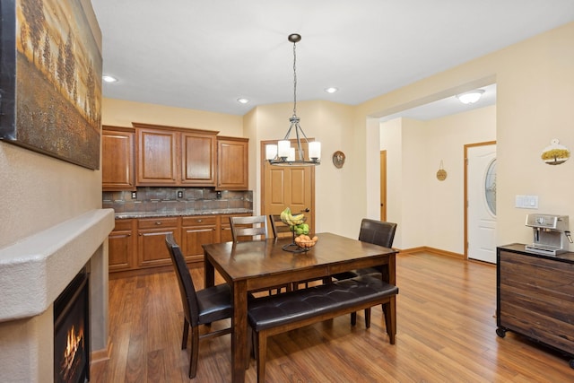 dining room featuring light hardwood / wood-style flooring and a notable chandelier