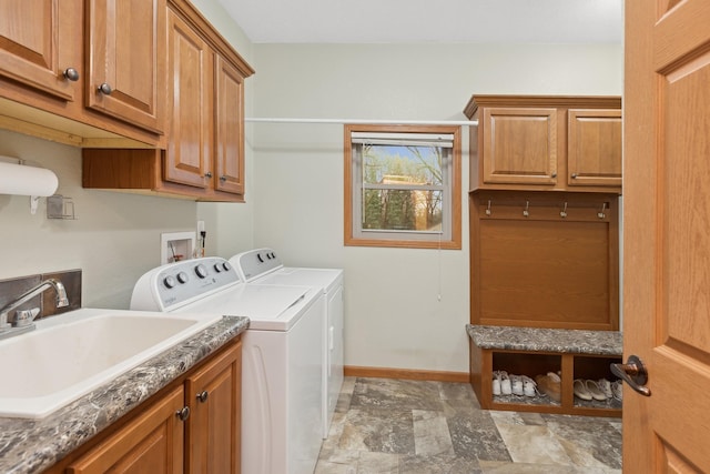 laundry room with sink, cabinets, and independent washer and dryer