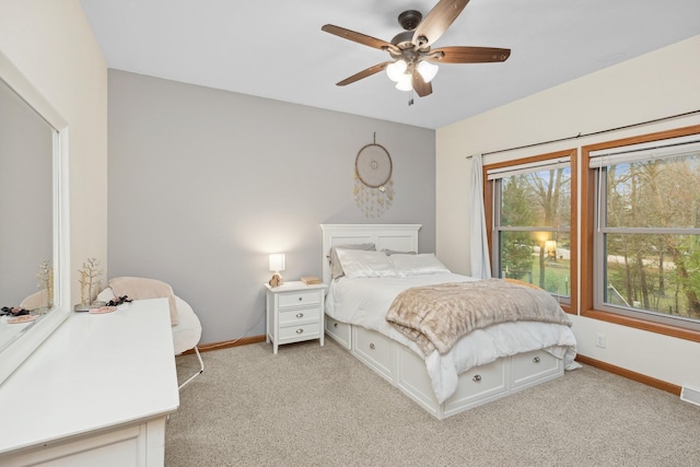 bedroom with ceiling fan and light colored carpet