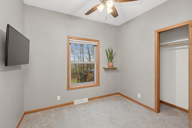 unfurnished bedroom with ceiling fan, a closet, and light colored carpet