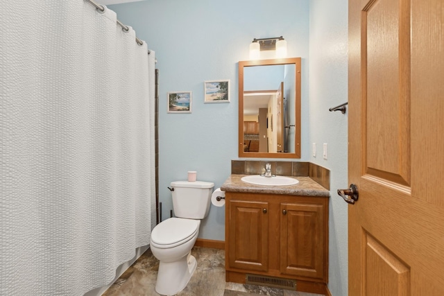 bathroom featuring vanity, toilet, and curtained shower