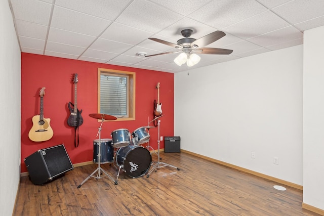 miscellaneous room with a paneled ceiling, hardwood / wood-style flooring, and ceiling fan