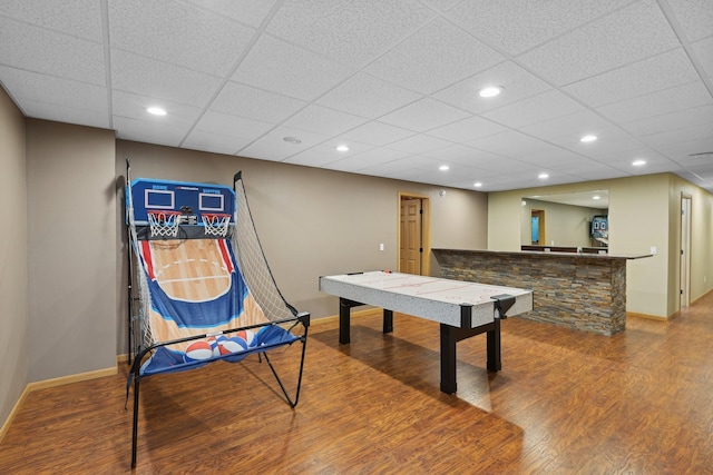 game room featuring a paneled ceiling and hardwood / wood-style flooring