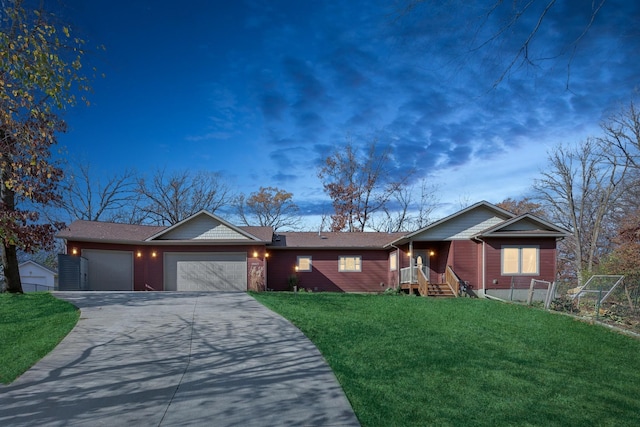 ranch-style home featuring a lawn and a garage