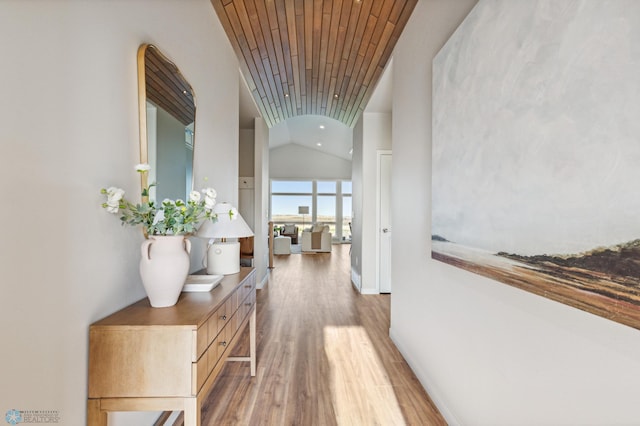 hall featuring lofted ceiling, wood-type flooring, and wooden ceiling