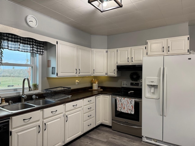 kitchen with stainless steel electric range, dark hardwood / wood-style flooring, white cabinetry, sink, and white refrigerator with ice dispenser