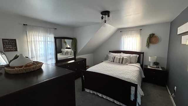 carpeted bedroom with lofted ceiling