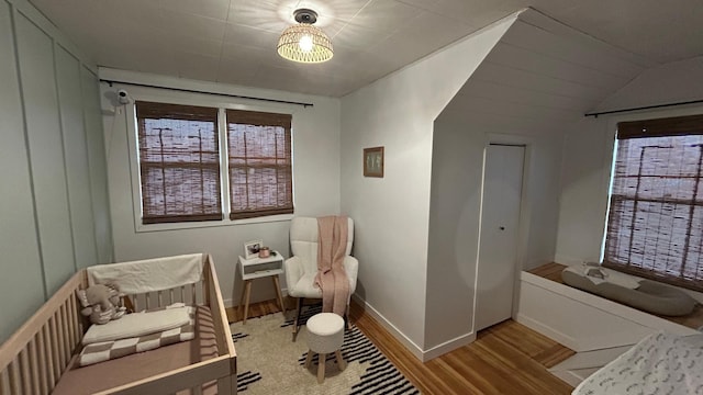 bedroom featuring light hardwood / wood-style floors and vaulted ceiling