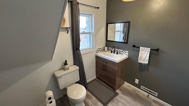 bathroom with vanity, toilet, and hardwood / wood-style flooring