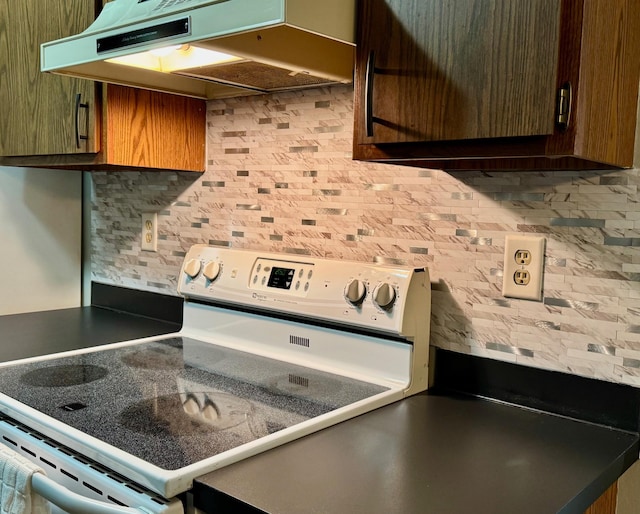 kitchen featuring tasteful backsplash and white electric range oven