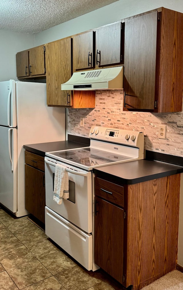 kitchen with white appliances and a textured ceiling