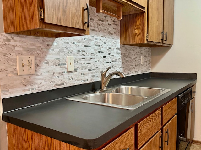 kitchen featuring sink, decorative backsplash, and black dishwasher