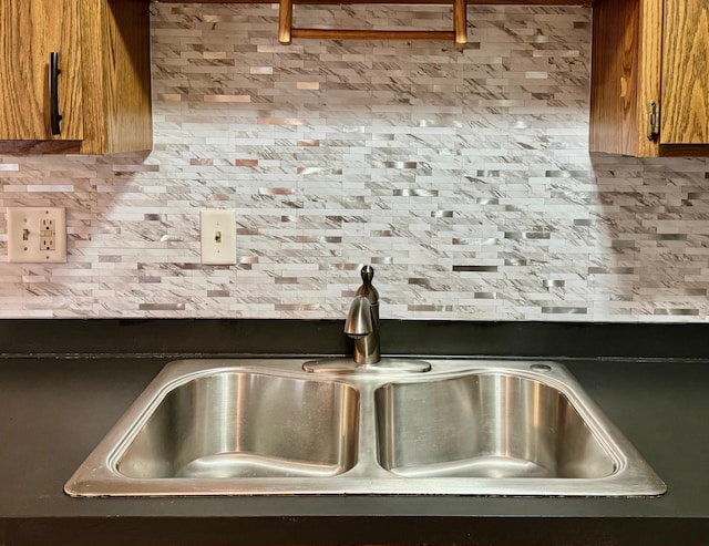 room details featuring backsplash and sink