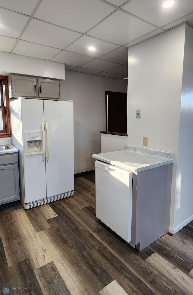 kitchen featuring gray cabinets, dark wood-type flooring, a paneled ceiling, and white fridge with ice dispenser