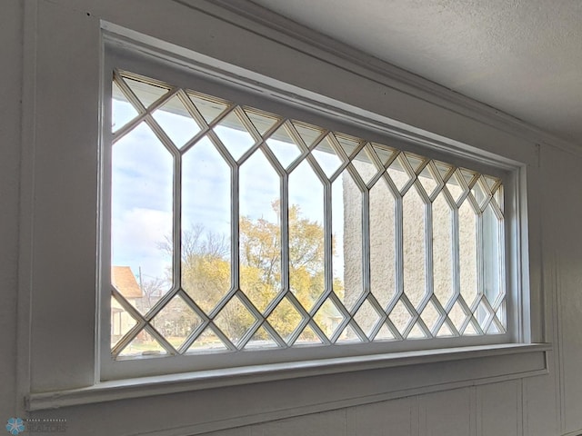 details with crown molding and a textured ceiling