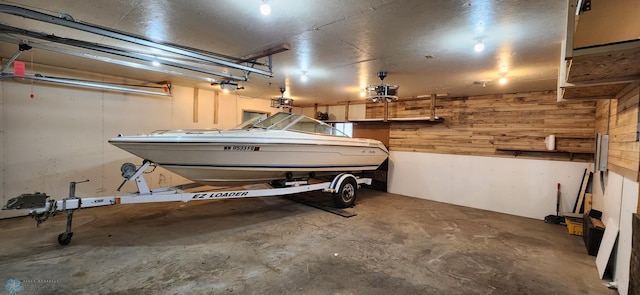 garage featuring wood walls and a garage door opener