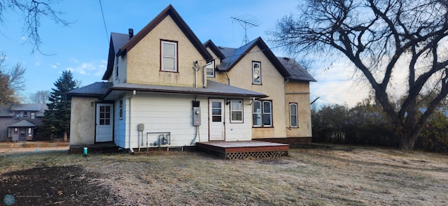 rear view of house featuring a deck