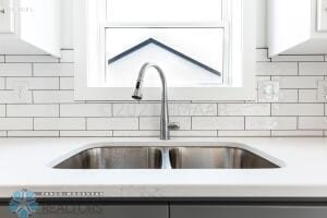 8447 61st St S, Horace, ND 58047 - kitchen view of a sink, tasteful backsplash, and light countertops