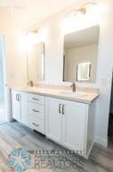 8447 61st St S, Horace, ND 58047 - full bath with double vanity and wood finished floors