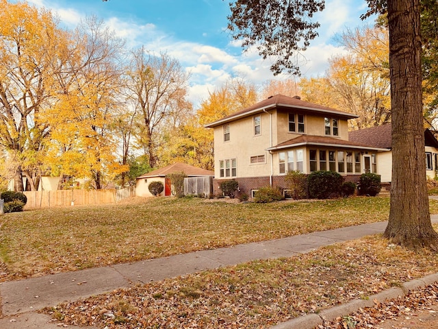 view of side of home with a yard