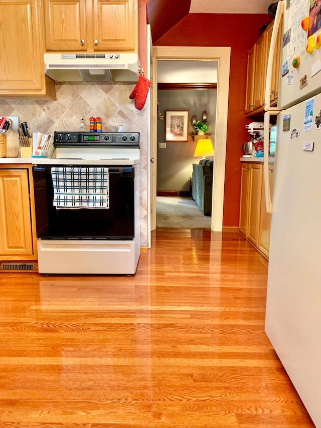 kitchen featuring light hardwood / wood-style flooring, tasteful backsplash, and white appliances