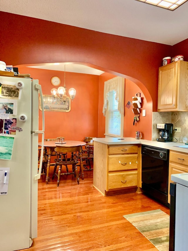 kitchen featuring light hardwood / wood-style floors, dishwasher, pendant lighting, and white refrigerator