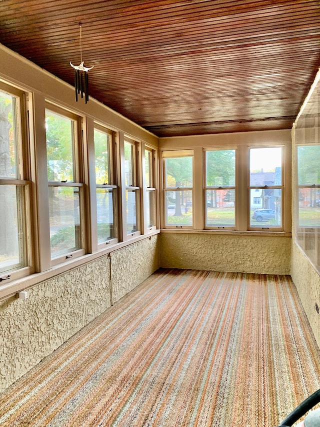 unfurnished sunroom featuring wooden ceiling