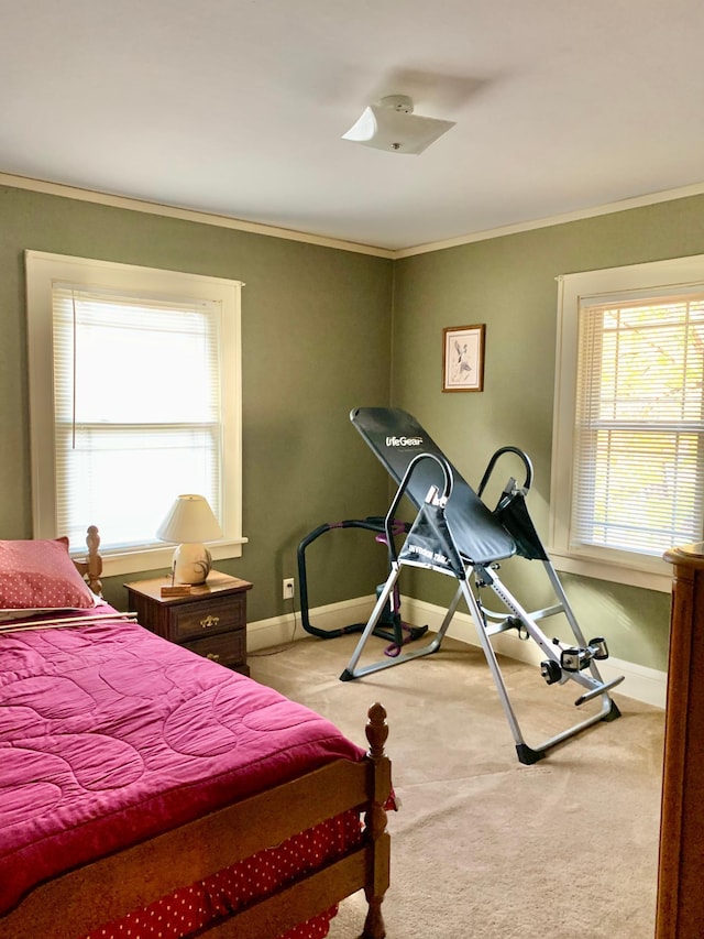 carpeted bedroom with ornamental molding