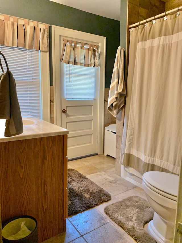 bathroom with vanity, toilet, and curtained shower