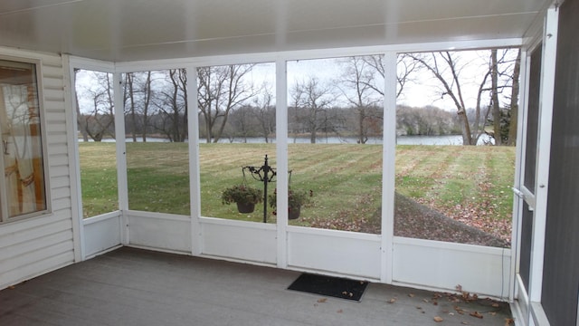 unfurnished sunroom with a water view