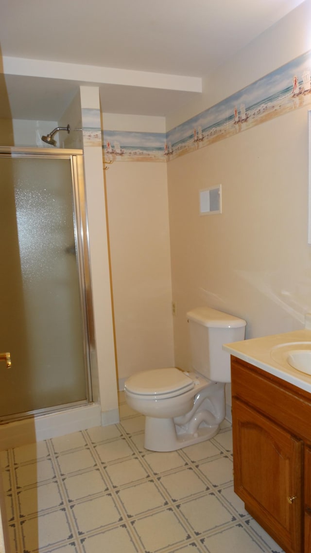 bathroom with toilet, vanity, and an enclosed shower