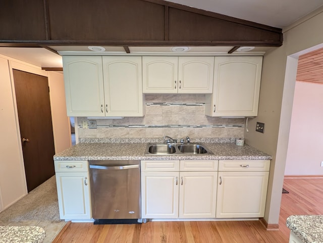 kitchen featuring decorative backsplash, white cabinetry, dishwasher, light hardwood / wood-style floors, and sink