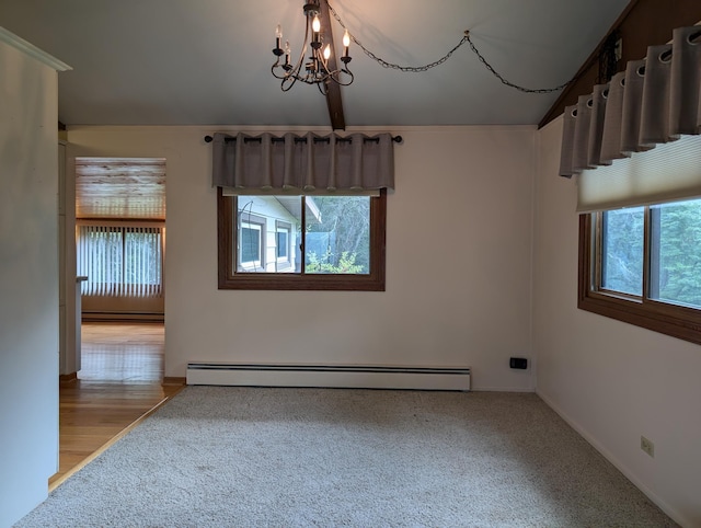 spare room featuring baseboard heating, a chandelier, and light wood-type flooring