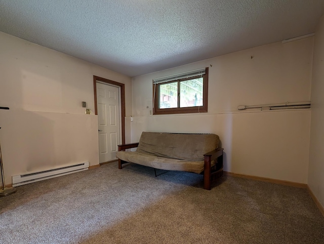 unfurnished room featuring a textured ceiling, a baseboard heating unit, and carpet flooring