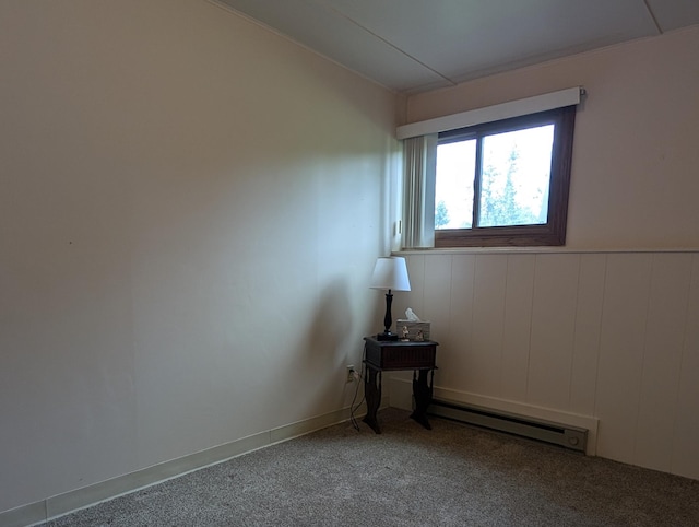 empty room with a baseboard heating unit and carpet